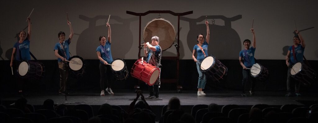 Seven taiko drummers on stage at The Hollywood Theatre